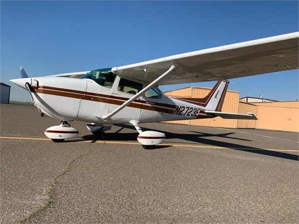 Front-left exterior view of Cessna 172N N2723E parked on the ramp, available for rental at Augusta Regional Airport.